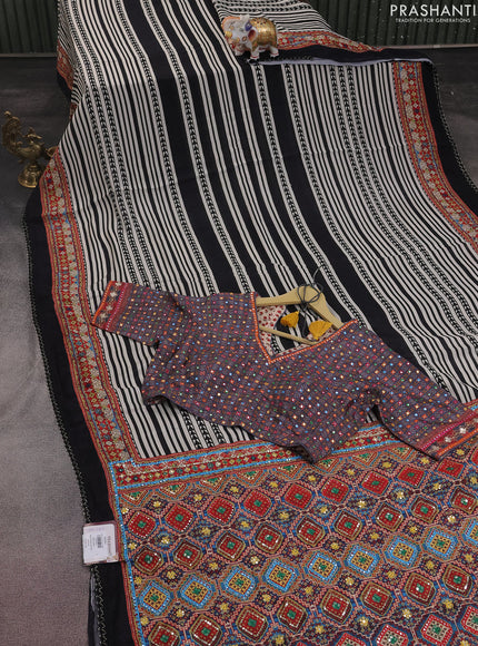 Crepe silk saree off white black and pastel violet with patola prints & embroidery mirror work pallu