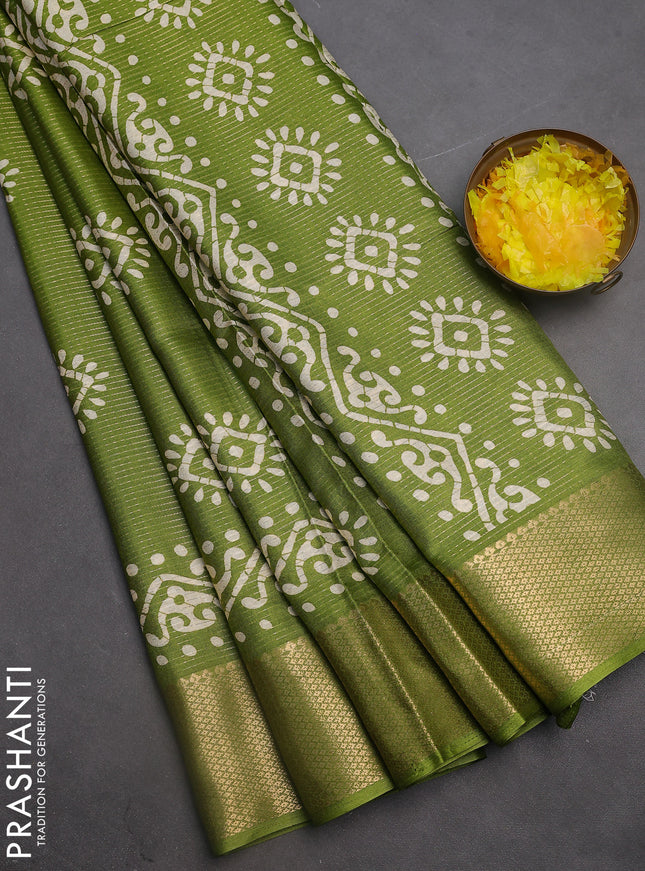 Semi dola saree light green with allover zari weaves & batik butta prints and zari woven border
