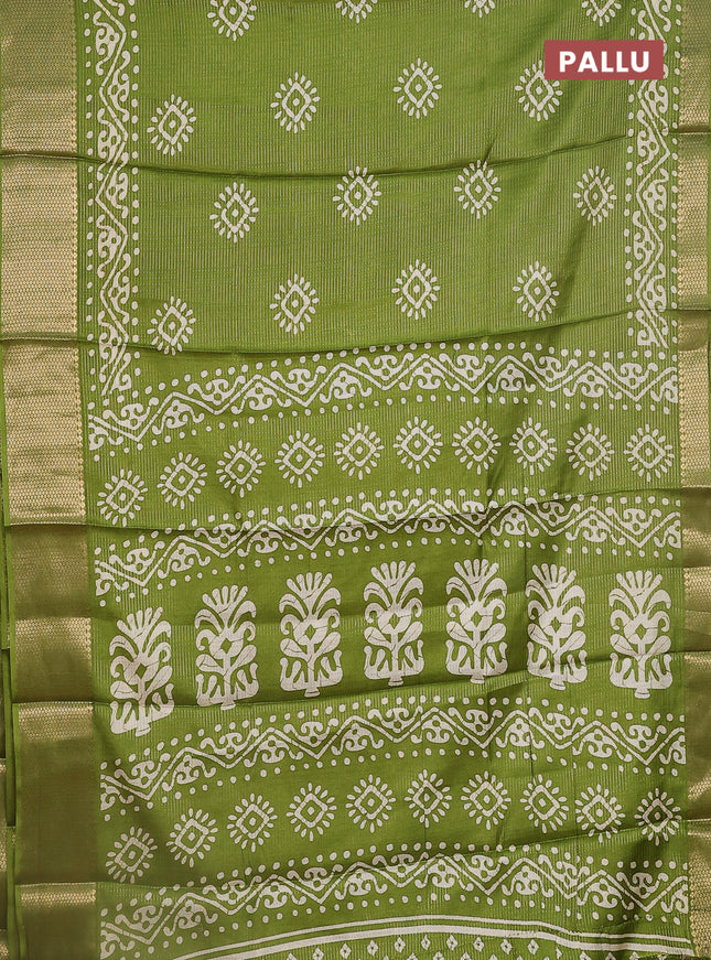 Semi dola saree light green with allover zari weaves & batik butta prints and zari woven border
