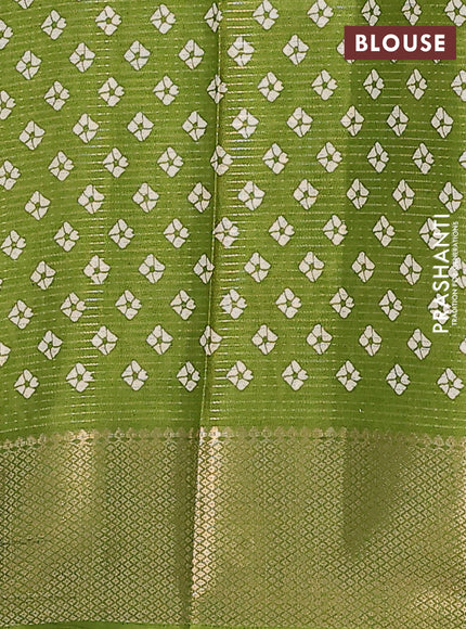 Semi dola saree light green with allover zari weaves & batik butta prints and zari woven border