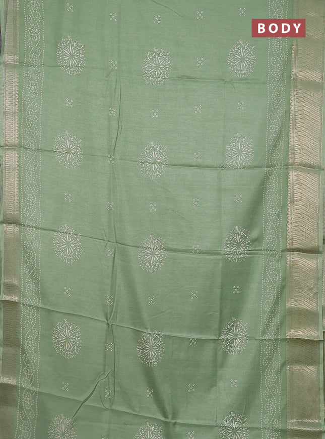 Semi dola saree pastel green with bandhani butta prints and zari woven border