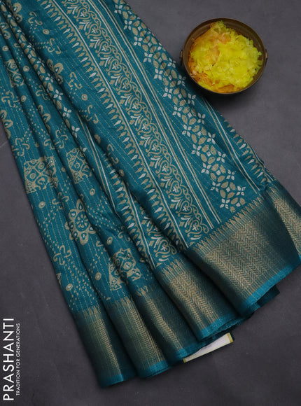 Semi dola saree teal blue with allover zari stripes & prints and zari woven border