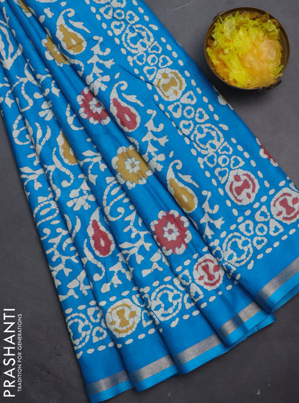 Semi dola saree cs blue with allover batik prints and zari woven border