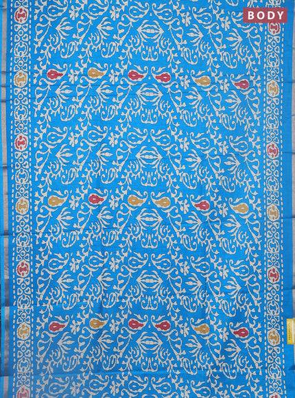 Semi dola saree cs blue with allover batik prints and zari woven border