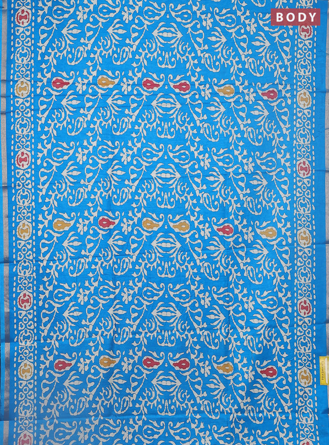 Semi dola saree cs blue with allover batik prints and zari woven border