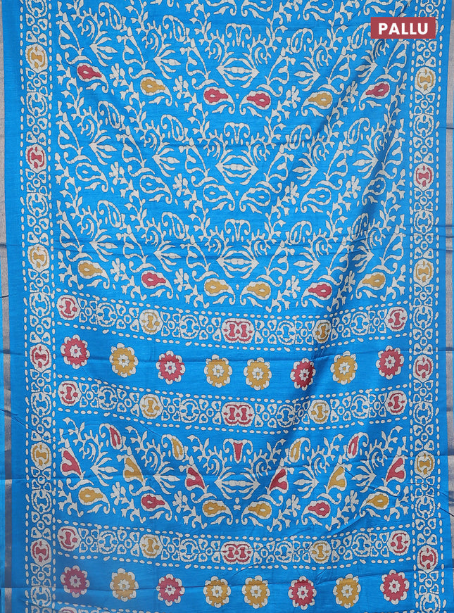 Semi dola saree cs blue with allover batik prints and zari woven border
