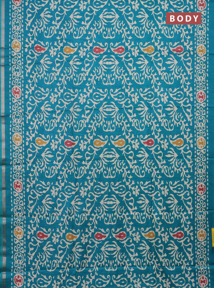 Semi dola saree teal blue with allover batik prints and zari woven border