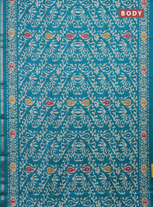 Semi dola saree teal blue with allover batik prints and zari woven border