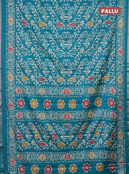Semi dola saree teal blue with allover batik prints and zari woven border