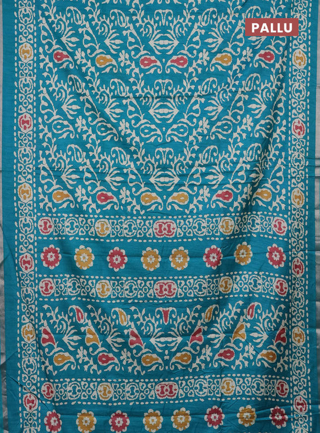 Semi dola saree teal blue with allover batik prints and zari woven border