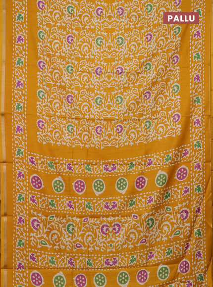 Semi dola saree mustard yellow with allover batik prints and zari woven border
