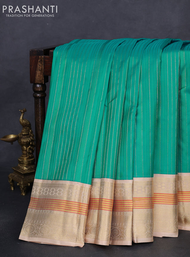 Pure kanchipuram silk saree teal blue and sandal with allover self emboss & zari weaves and zari woven korvai border