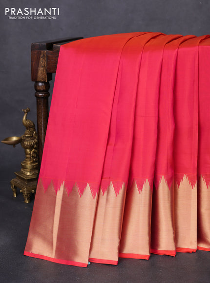 Pure kanchipuram silk saree dual shade of pinkish orange with plain body and temple design zari woven border