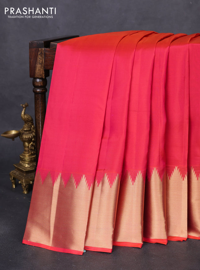 Pure kanchipuram silk saree dual shade of pinkish orange with plain body and temple design zari woven border
