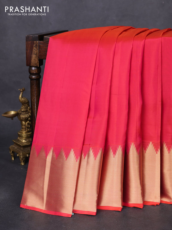 Pure kanchipuram silk saree dual shade of pinkish orange with plain body and temple design zari woven border