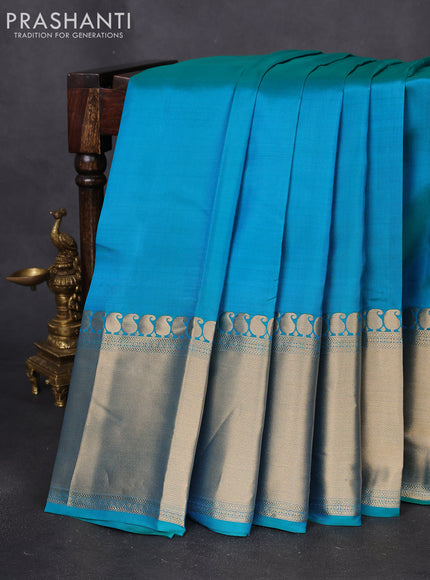 Pure kanchipuram silk saree dual shade of teal blue with plain body and long zari woven border