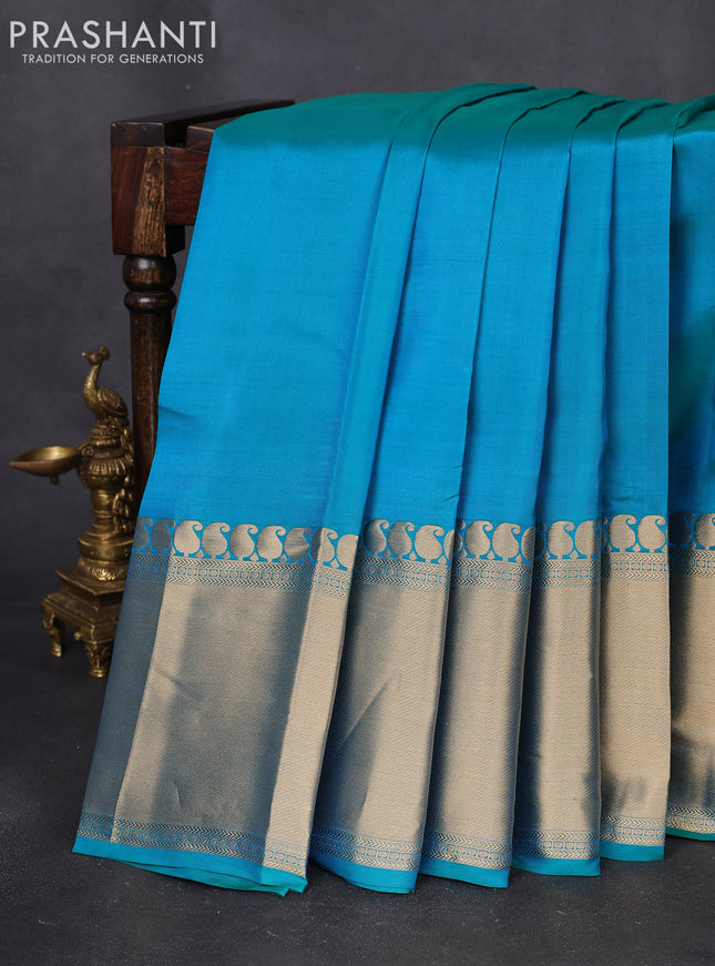 Pure kanchipuram silk saree dual shade of teal blue with plain body and long zari woven border