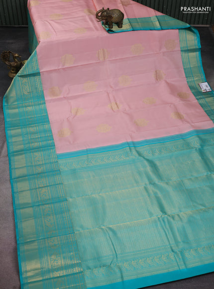 Pure kanchipuram silk saree pastel peach and teal blue with zari woven buttas and long zari woven korvai border