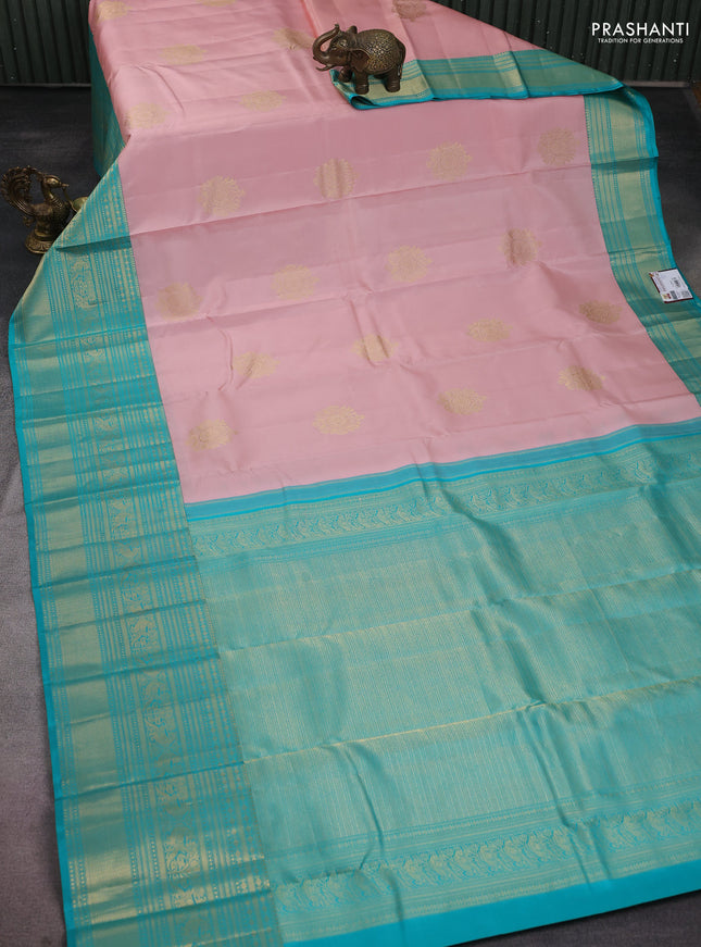 Pure kanchipuram silk saree pastel peach and teal blue with zari woven buttas and long zari woven korvai border