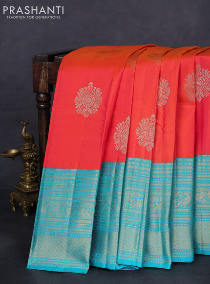 Pure kanchipuram silk saree dual shade of pinkish orange and teal blue with zari woven buttas and long zari woven korvai border