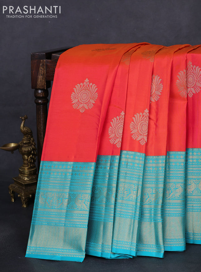 Pure kanchipuram silk saree dual shade of pinkish orange and teal blue with zari woven buttas and long zari woven korvai border