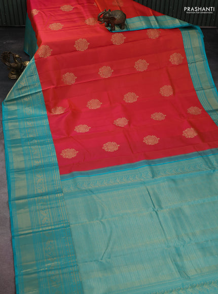 Pure kanchipuram silk saree dual shade of pinkish orange and teal blue with zari woven buttas and long zari woven korvai border
