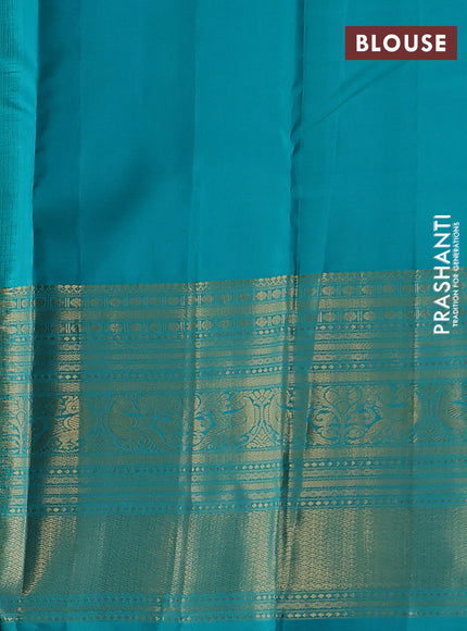 Pure kanchipuram silk saree dual shade of pinkish orange and teal blue with zari woven buttas and long zari woven korvai border