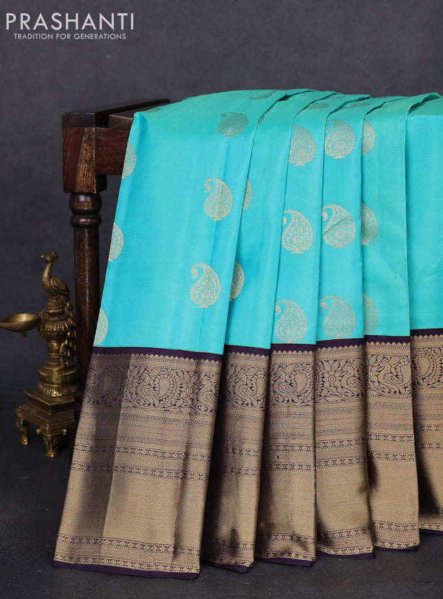 Pure kanchipuram silk saree teal blue and wine shade with paisley zari woven buttas and long annam zari woven korvai border