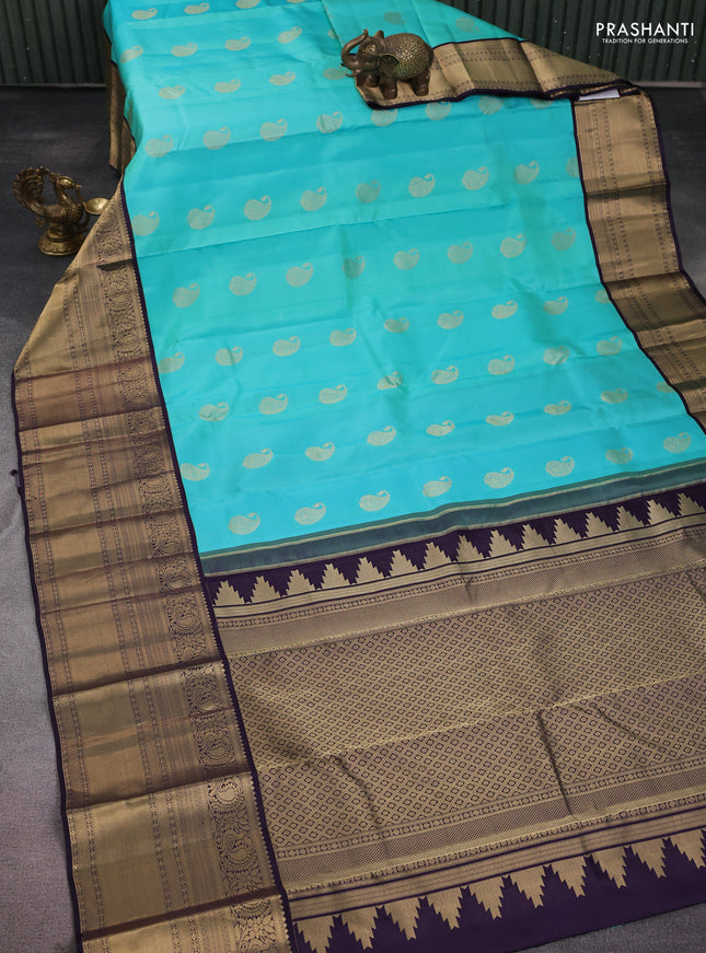 Pure kanchipuram silk saree teal blue and wine shade with paisley zari woven buttas and long annam zari woven korvai border