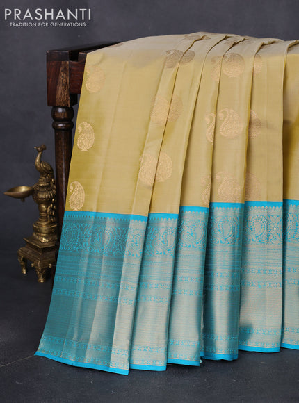 Pure kanchipuram silk saree cream and teal blue with paisley zari woven buttas and long annam zari woven korvai border