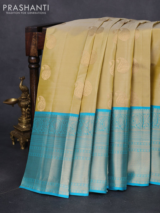 Pure kanchipuram silk saree cream and teal blue with paisley zari woven buttas and long annam zari woven korvai border