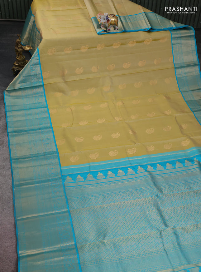 Pure kanchipuram silk saree cream and teal blue with paisley zari woven buttas and long annam zari woven korvai border