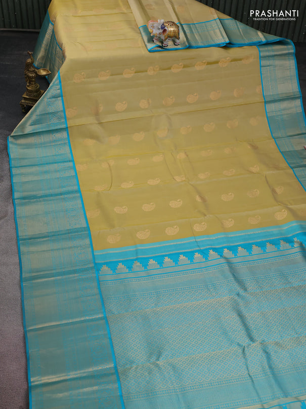Pure kanchipuram silk saree cream and teal blue with paisley zari woven buttas and long annam zari woven korvai border