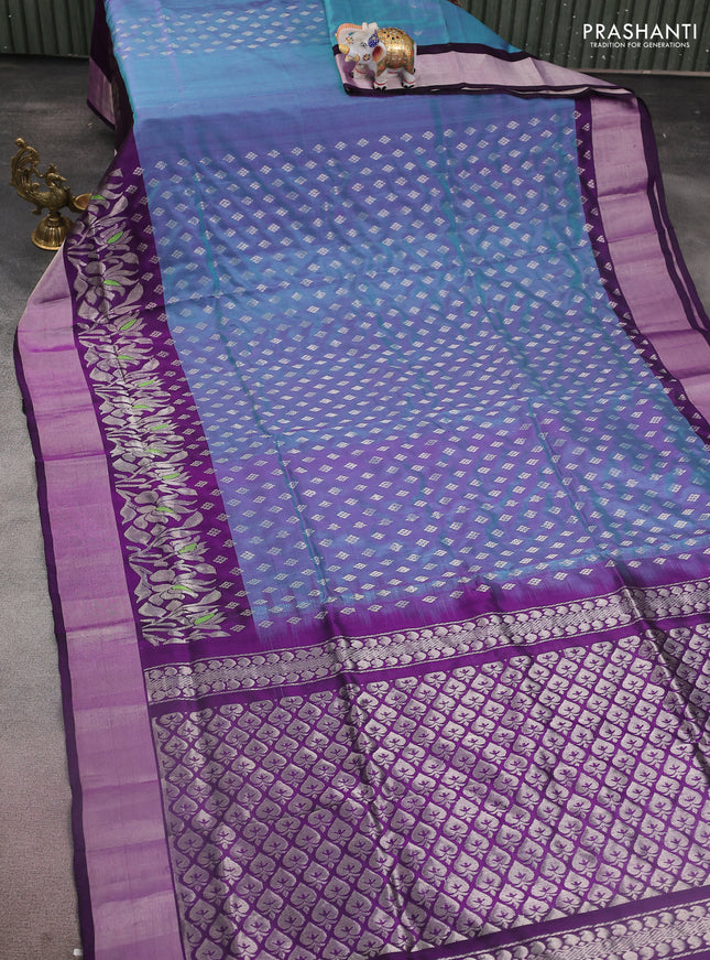 Pure uppada silk saree dual shade of blue and deep purple with allover silver zari woven buttas and floral design silver zari woven border