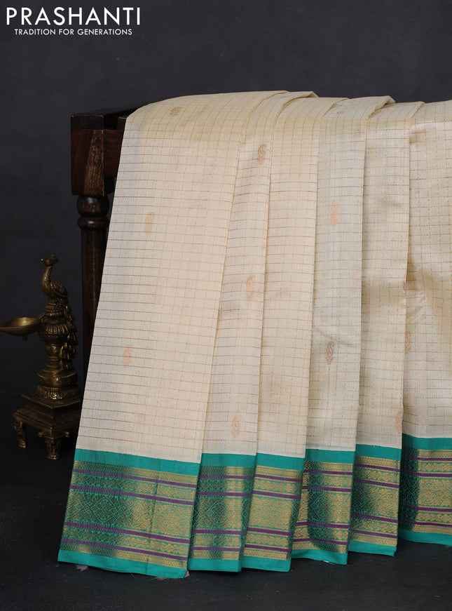 Silk cotton saree cream and teal green with allover zari checks & buttas and zari woven korvai border