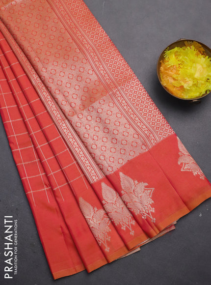 Semi soft silk saree dual shade of pinkish orange with allover zari woven checked pattern and zari woven butta border
