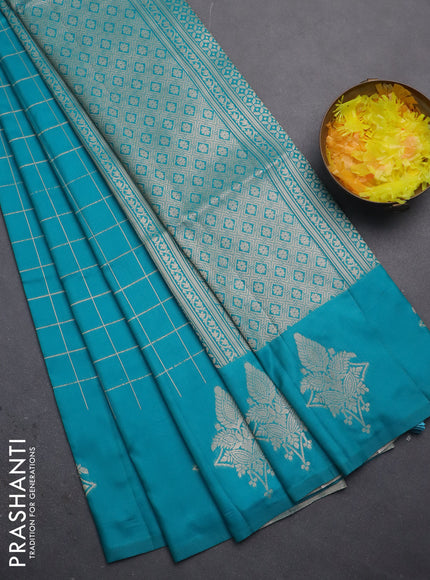 Semi soft silk saree teal blue shade with allover zari woven checked pattern and zari woven butta border