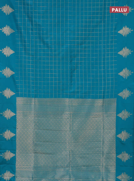 Semi soft silk saree teal blue shade with allover zari woven checked pattern and zari woven butta border