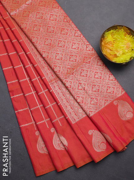Semi soft silk saree dual shade of pinkish orange with allover zari woven checked pattern and zari woven butta border