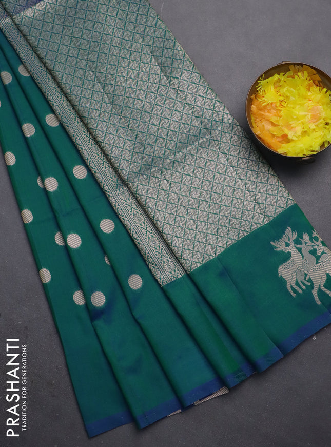 Semi soft silk saree dual shade of greenish blue with zari woven coin buttas and zari woven deer butta border