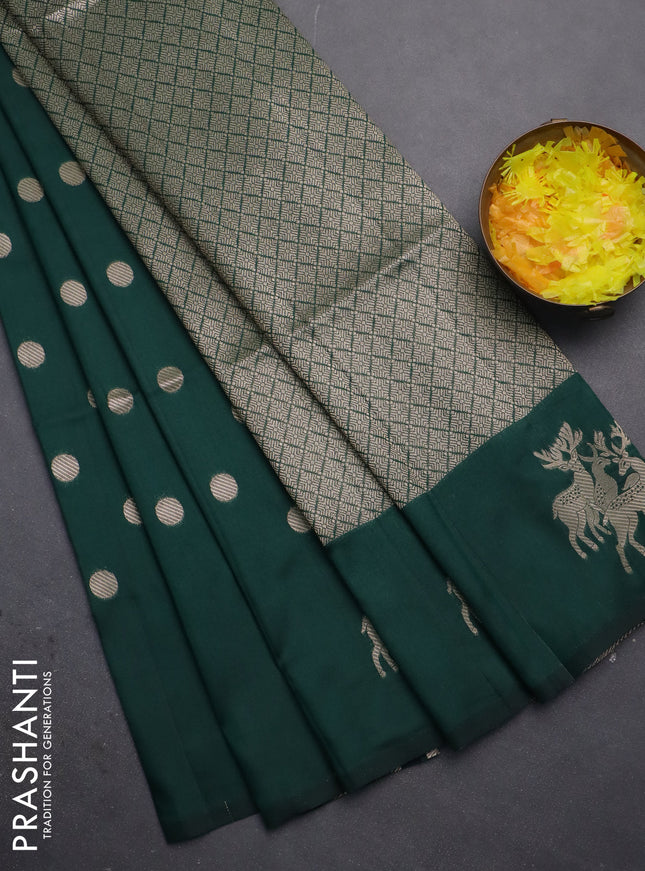 Semi soft silk saree dark green with zari woven coin buttas and zari woven deer butta border