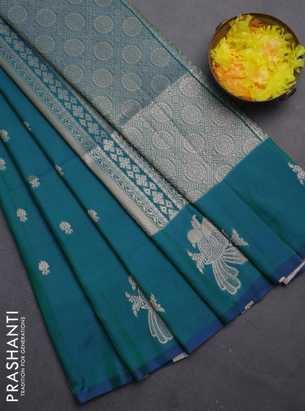 Semi soft silk saree dual shade of bluish green with allover zari woven buttas with zari woven bird butta border