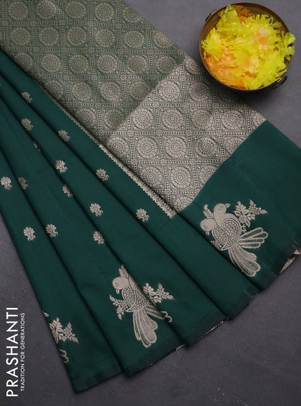Semi soft silk saree dark green with allover zari woven buttas with zari woven bird butta border