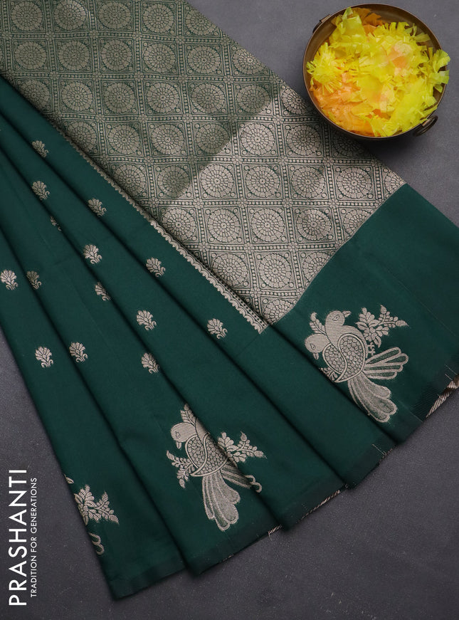 Semi soft silk saree dark green with allover zari woven buttas with zari woven bird butta border