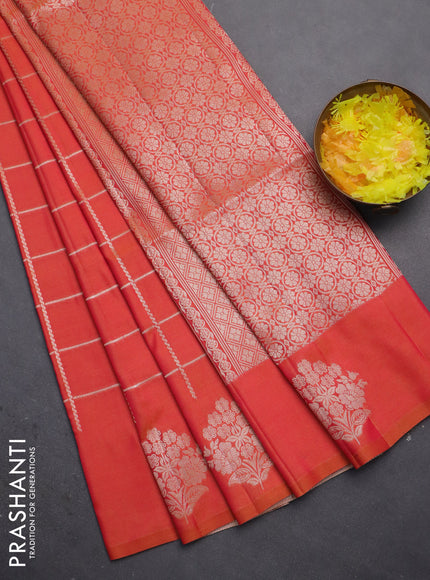 Semi soft silk saree dual shade of pinkisha orange with allover zari woven checked pattern and zari woven floral butta border