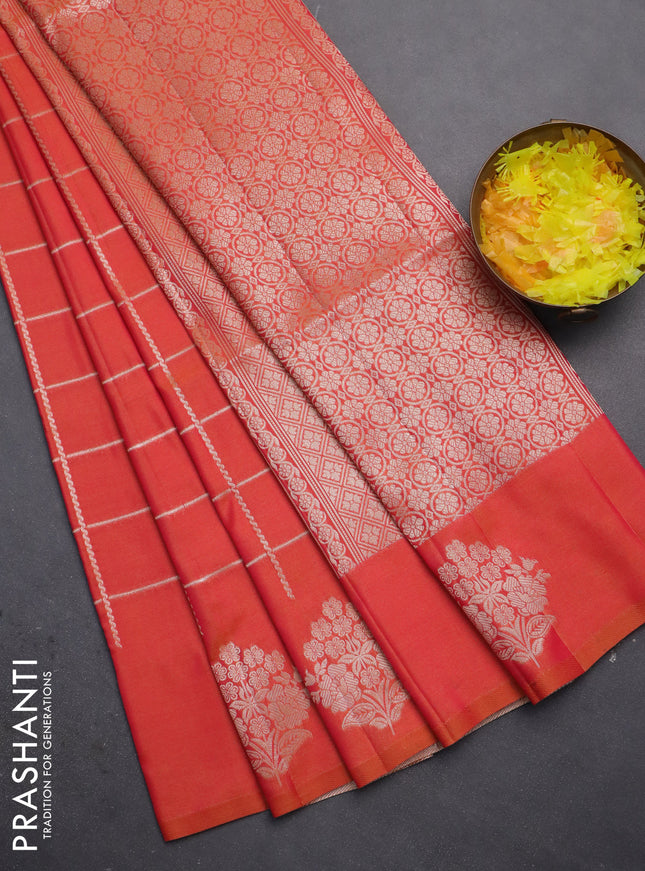 Semi soft silk saree dual shade of pinkisha orange with allover zari woven checked pattern and zari woven floral butta border
