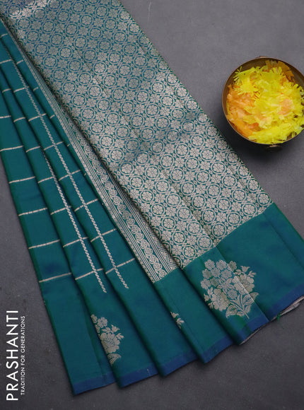 Semi soft silk saree dual shade of greenish blue with allover zari woven checked pattern and zari woven floral butta border