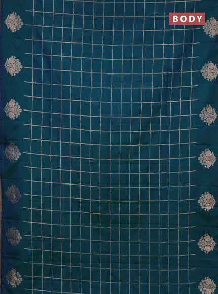Semi soft silk saree dual shade of greenish blue with allover zari woven checked pattern and zari woven floral butta border