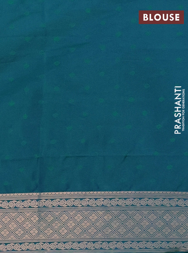 Semi soft silk saree dual shade of greenish blue with allover zari woven checked pattern and zari woven floral butta border