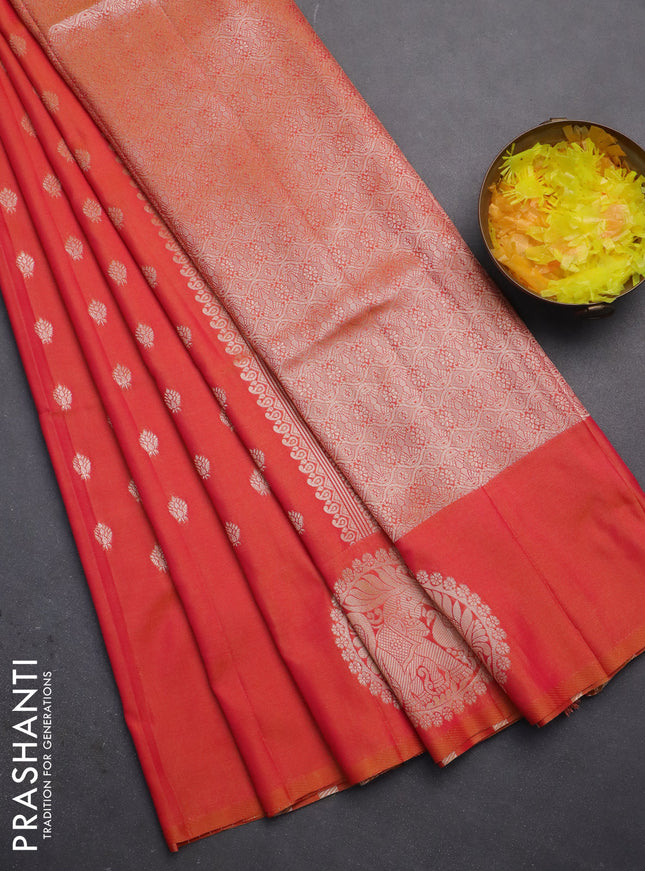 Semi soft silk saree dual shade of pinkish orange with allover zari woven buttas and zari woven butta border